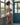 Woman in a blue bikini standing in a room with large windows and a blue door.
