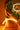 Statue of a woman holding glowing neon rings against an orange background