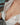 Partial view of a person wearing an open white shirt.