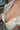 Partial view of a person wearing an open white shirt.