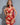 A woman wearing a red lingerie set with lace details and a G-string design.
