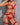 A woman wearing a red lingerie set with lace details and a G-string design.