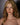 A highly realistic silicone doll with long blonde hair and blue eyes, designed to resemble a lifelike woman.