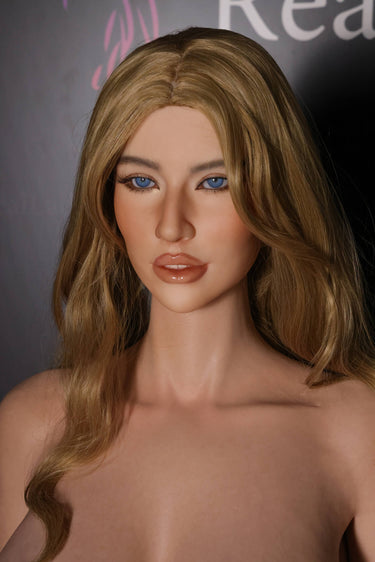 A highly realistic silicone doll with long blonde hair and blue eyes, designed to resemble a lifelike woman.