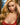 A highly realistic light tan sex doll with long blonde hair and a red dress, posed with a gentle expression.