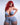 A realistic sex doll with red hair, wearing a blue crop top and matching skirt. The doll has a lifelike appearance with detailed features, including a prominent bust and curves.