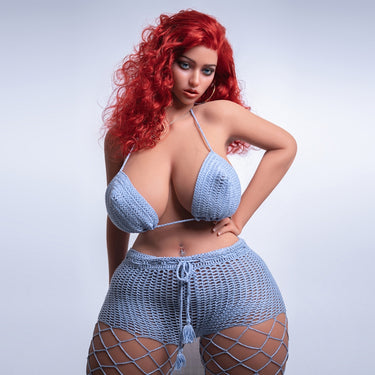 A realistic sex doll with red hair, wearing a blue crop top and matching skirt. The doll has a lifelike appearance with detailed features, including a prominent bust and curves.