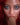 Dildo in a mouth of a sex doll with red hair.