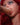 Dildo in a mouth of a sex doll with red hair.