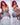 A sex doll with red hair in blue lingerie sitting on a chair, touching her boobs in white background.