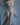 Model wearing a light blue lingerie set against a gray background