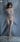 Model wearing a light blue lingerie set against a gray background