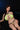 Woman wearing a green bikini against a dark background