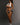 A highly realistic sex doll standing wearing only panty.