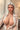 A realistic sex doll with silver hair, wearing a white shirt. The doll has a lifelike appearance with detailed features, including a prominent bust and curves.