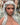 A realistic sex doll with Silver hair, in nude The doll has a lifelike appearance with detailed features, including a prominent bust and curves.