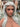 A realistic sex doll with Silver hair, in nude The doll has a lifelike appearance with detailed features, including a prominent bust and curves.