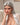 A realistic sex doll with silver hair, wearing a white shirt. The doll has a lifelike appearance with detailed features, including a prominent bust and curves.