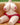 Plush toy with a red outfit on a beige couch