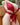 Red bikini worn by a mannequin against a blurred outdoor background