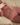 Naked person lying on a couch with a neutral background