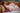 Realistic silicone doll lying on a couch with cushions