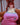 Person wearing a pink sports bra with 'Badblood Athletics' branding on a couch.