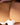 Close-up of a beige bra being held by hands.