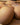 Naked person lying on a wooden floor with a wooden structure in the background
