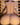 Naked statue against a wooden bookshelf background