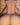 Naked human figure against a wooden slatted background