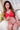Person wearing a red outfit with a white cross on a white couch.