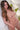 Sex doll with long brown hair in a decorative setting