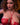 Woman wearing a red bikini with a dark background