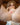 Sex doll in with golden hair laying nude on a brown sofa showing her pussy.