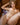 Sex doll in with golden hair laying nude on a brown sofa.