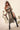 Woman in a costume holding a sword on a neutral background