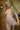 Sex doll with blonde hair and red lipstick on a wooden floor.