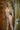 Realistic silicone doll with blonde hair and natural skin tone in a bathroom setting.