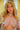 Realistic silicone doll with blonde hair and green eyes against a neutral background