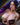 A sex doll with violet hair showing her boobs in a violet lingerie.