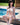 Woman in a bikini sitting by a pool
