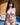 Woman in white lingerie standing by a pool