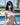 Woman in a white bikini standing by a pool with a scenic background