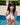 Person in a swimsuit by a pool with greenery in the background