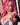 Sex doll with pink hair and denim outfit in a blurred indoor setting