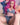Sex doll with pink hair and denim outfit on a neutral background