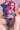 Sex doll with pink hair and denim outfit on a neutral background