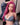 Person with pink hair wearing a denim outfit in an indoor setting