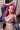 Person with pink hair wearing a denim outfit in an indoor setting